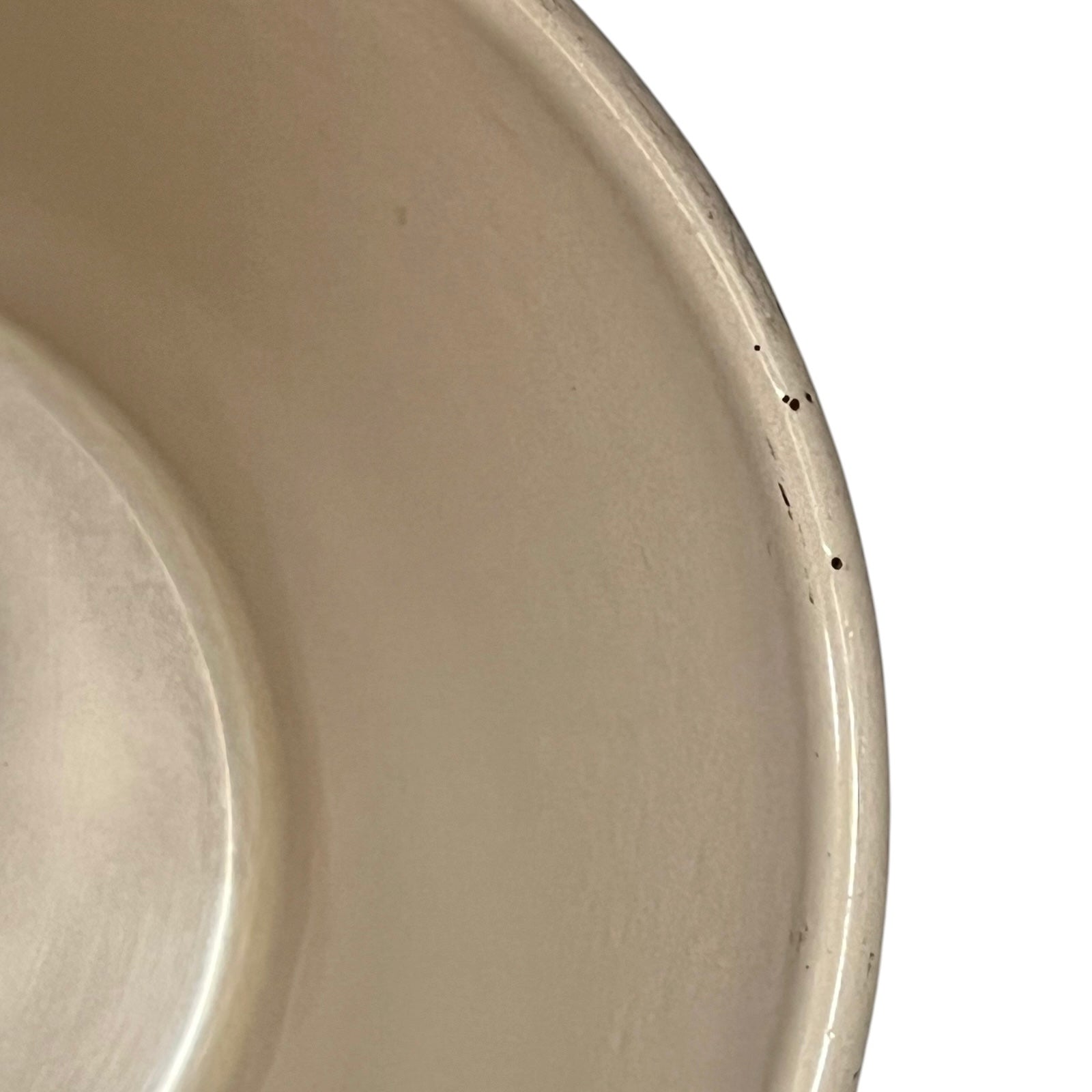 close up of  cast iron pan with beige interior on a white background