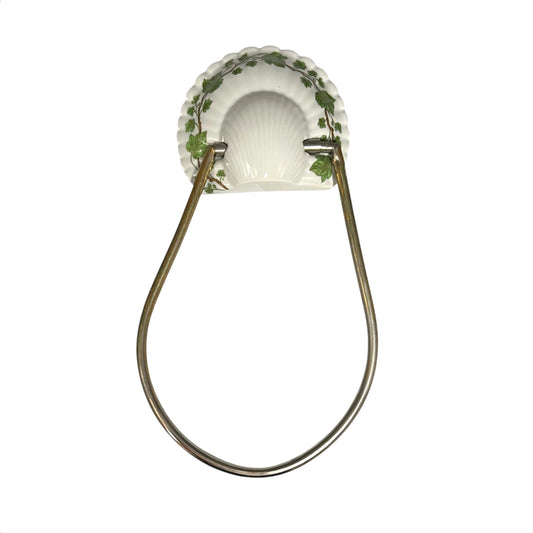 Decorative towel hoop with leaf design on a white background
