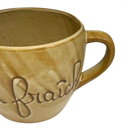 Ceramic pitcher with 'eau fraiche' text on a white background