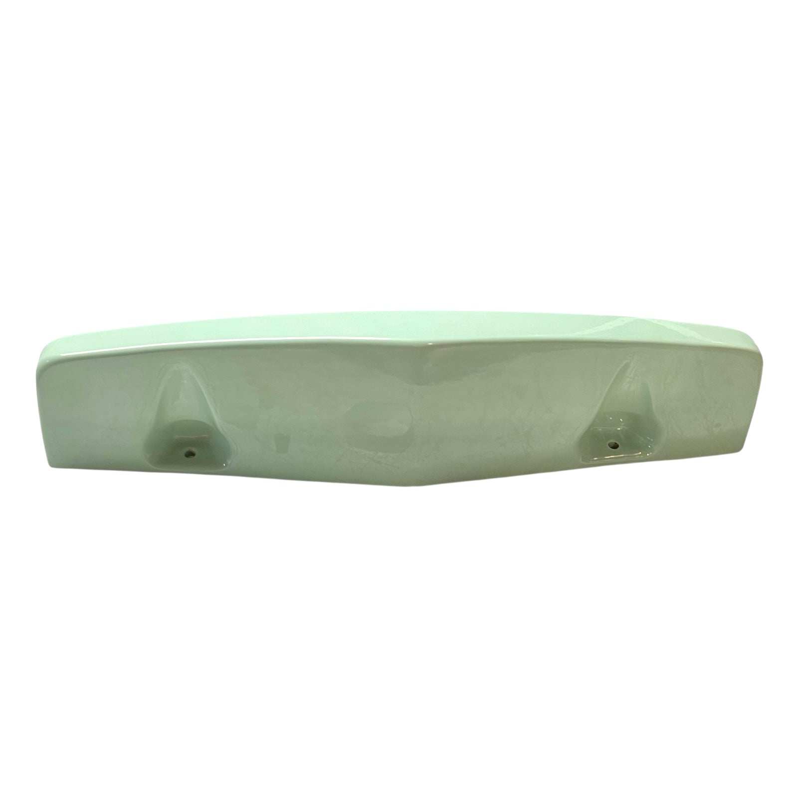 close up of pale green ceramic shelf on a white background