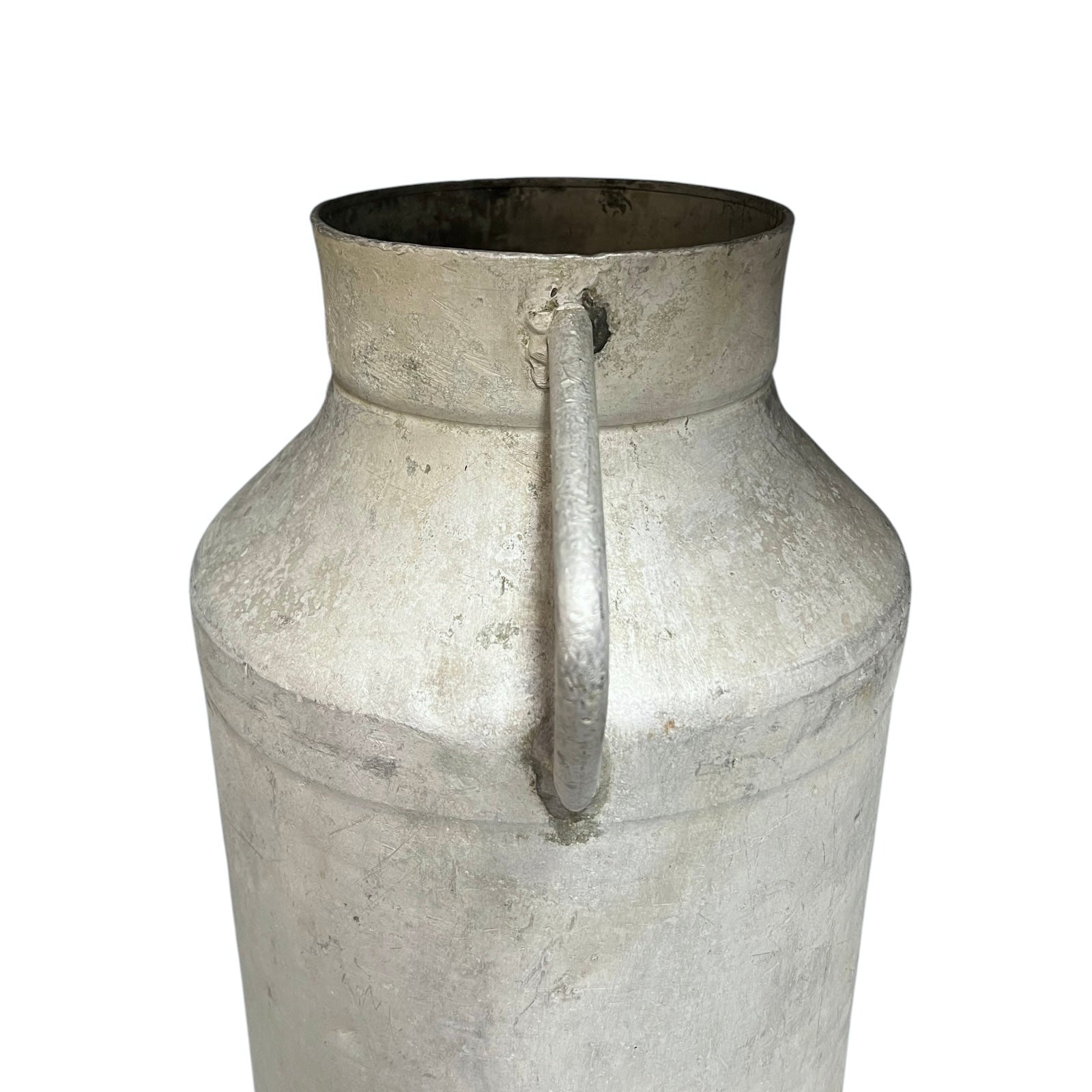 Close up of a vintage metal milk churn on a white background