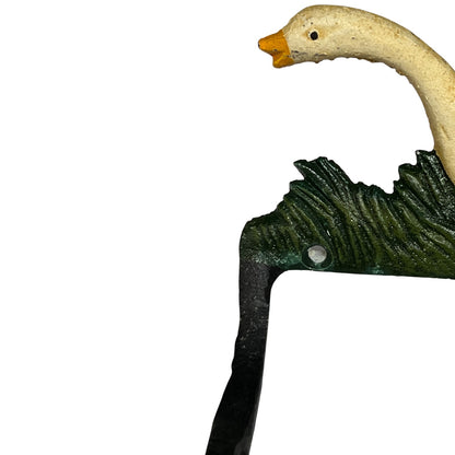 A close-up of a decorative metal toilet roll holder shaped like a goose head and neck, with a cream goose head, yellow beak, textured dark green neck, and black hook, shown against a plain white background.