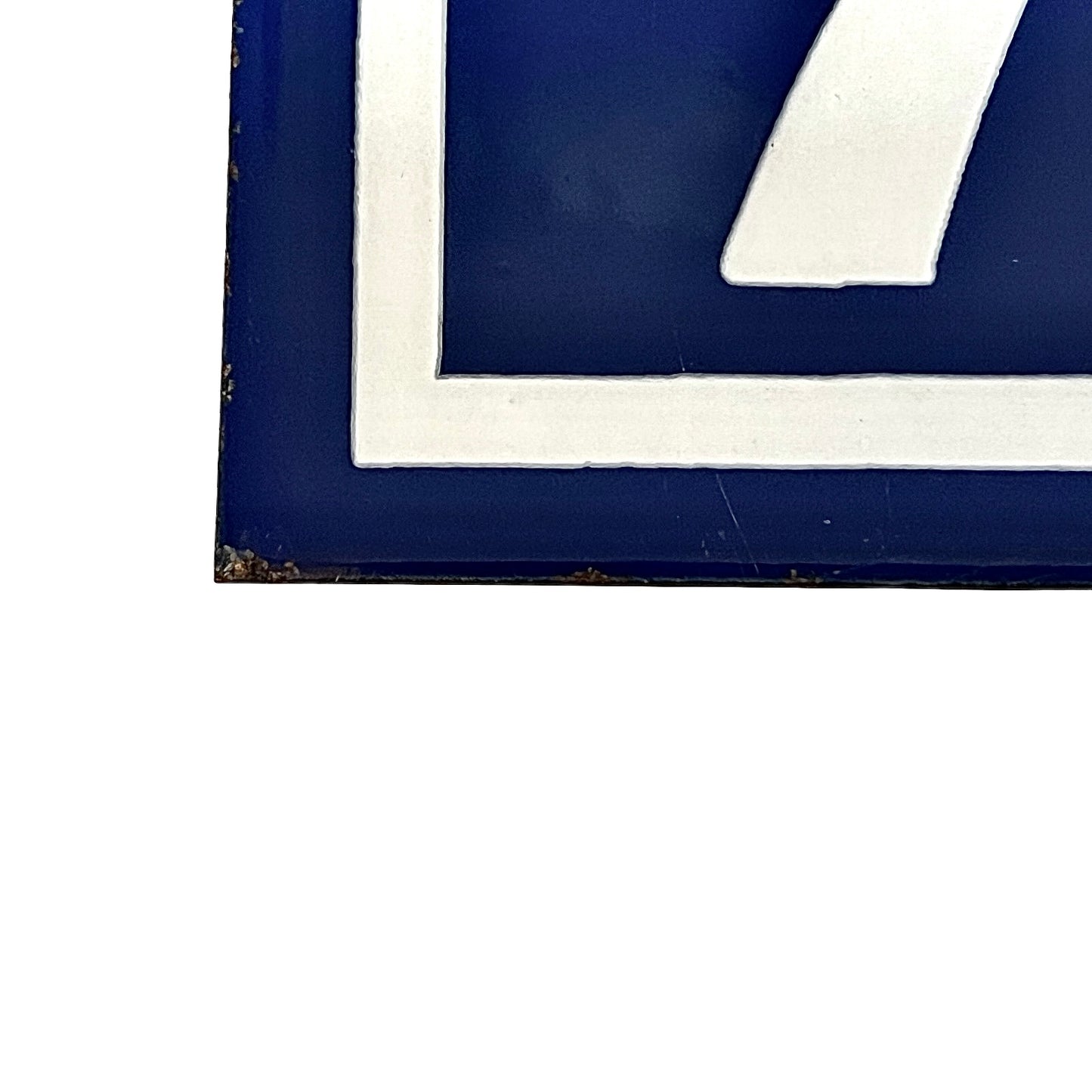Close up of a French blue and white enamel door number - bottom left corner