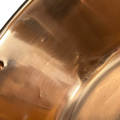 Close up of a French copper bathroom basin on a white background