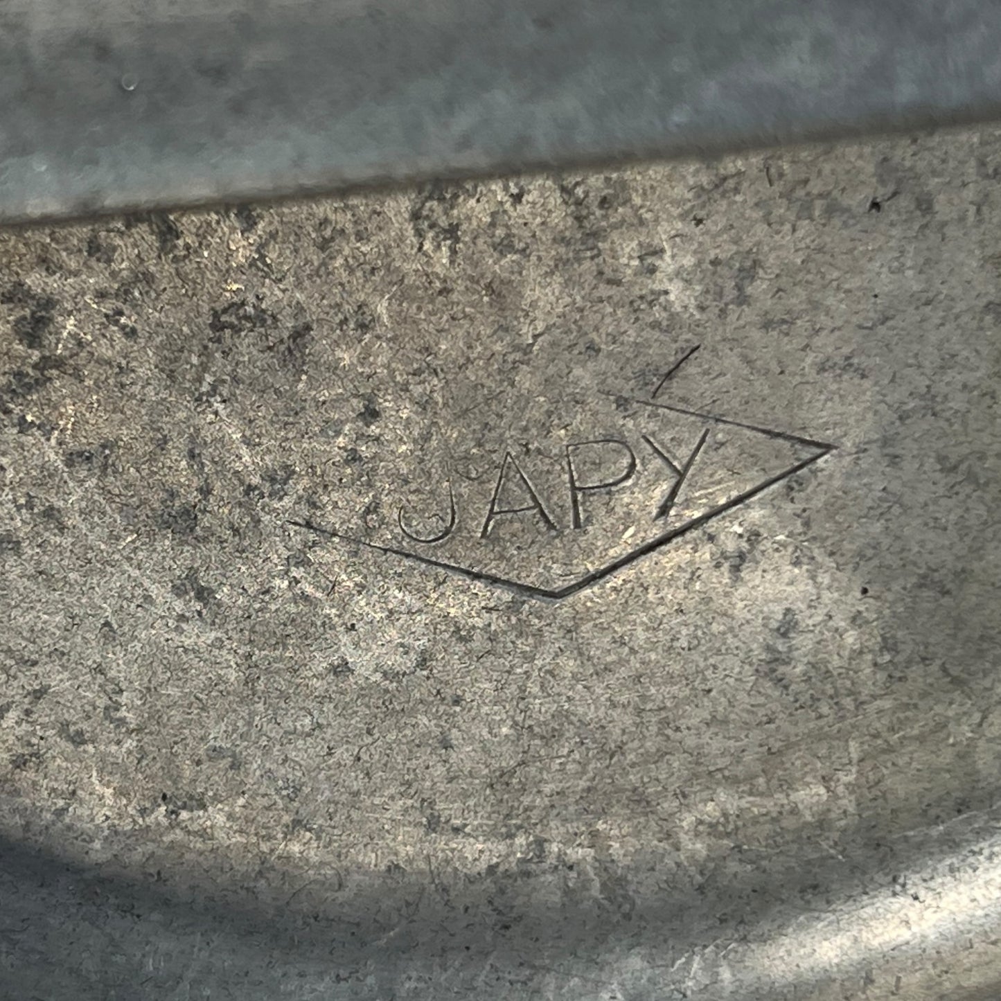close up of metal milk churn on a white background
