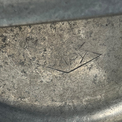 close up of metal milk churn on a white background