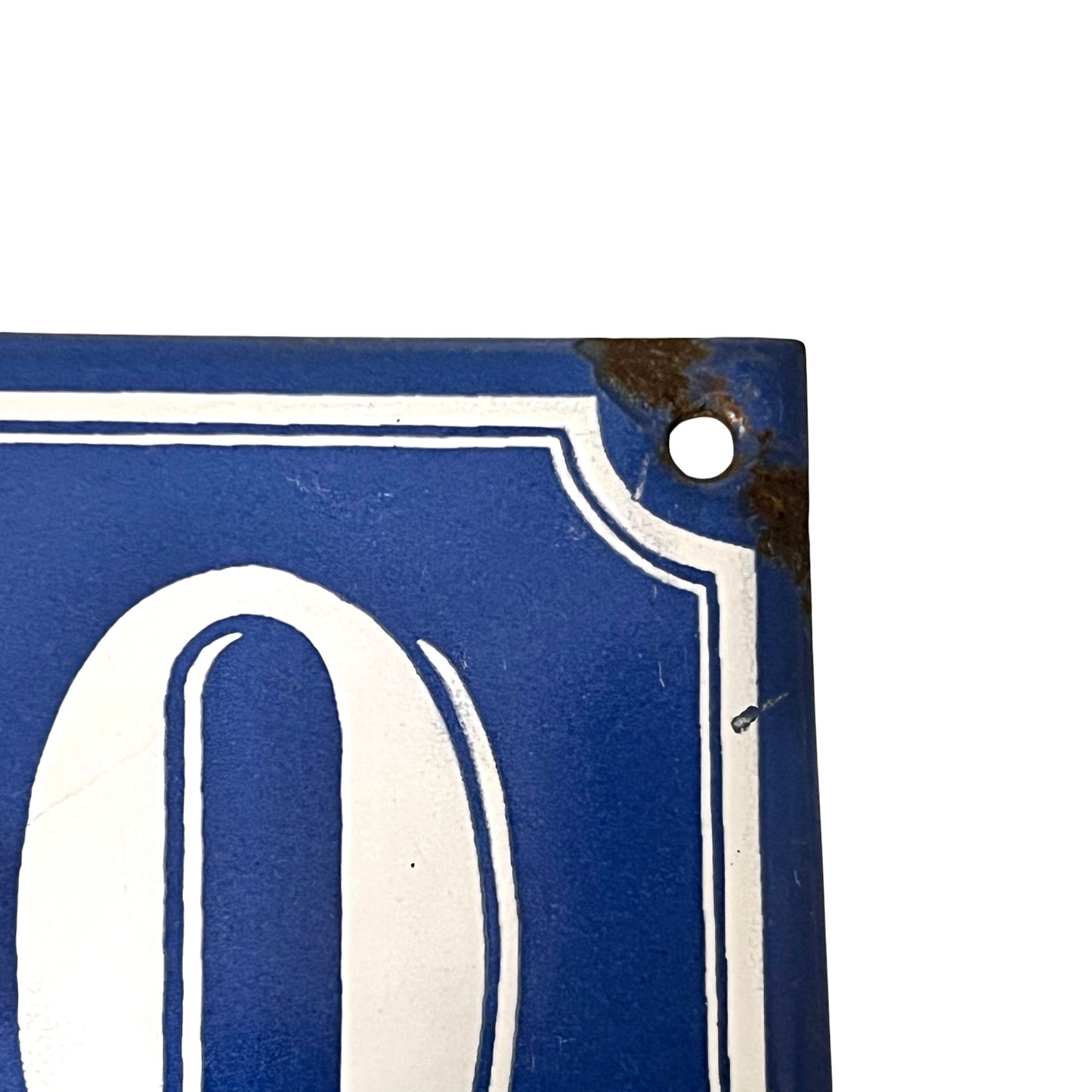 Close-up of a blue sign with a white numbers on a white background