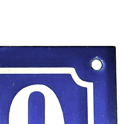 Blue metal sign with white letter 'O' on a white background
