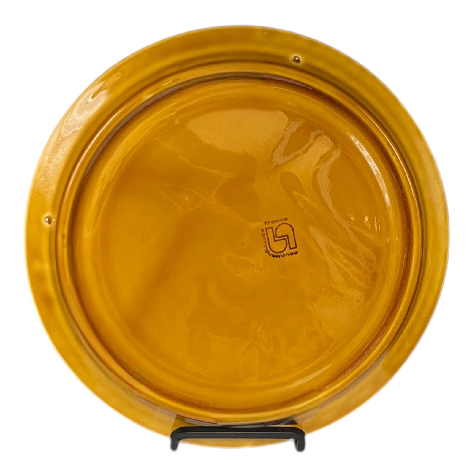 Back of fondue plate showing makers stamp on a white background