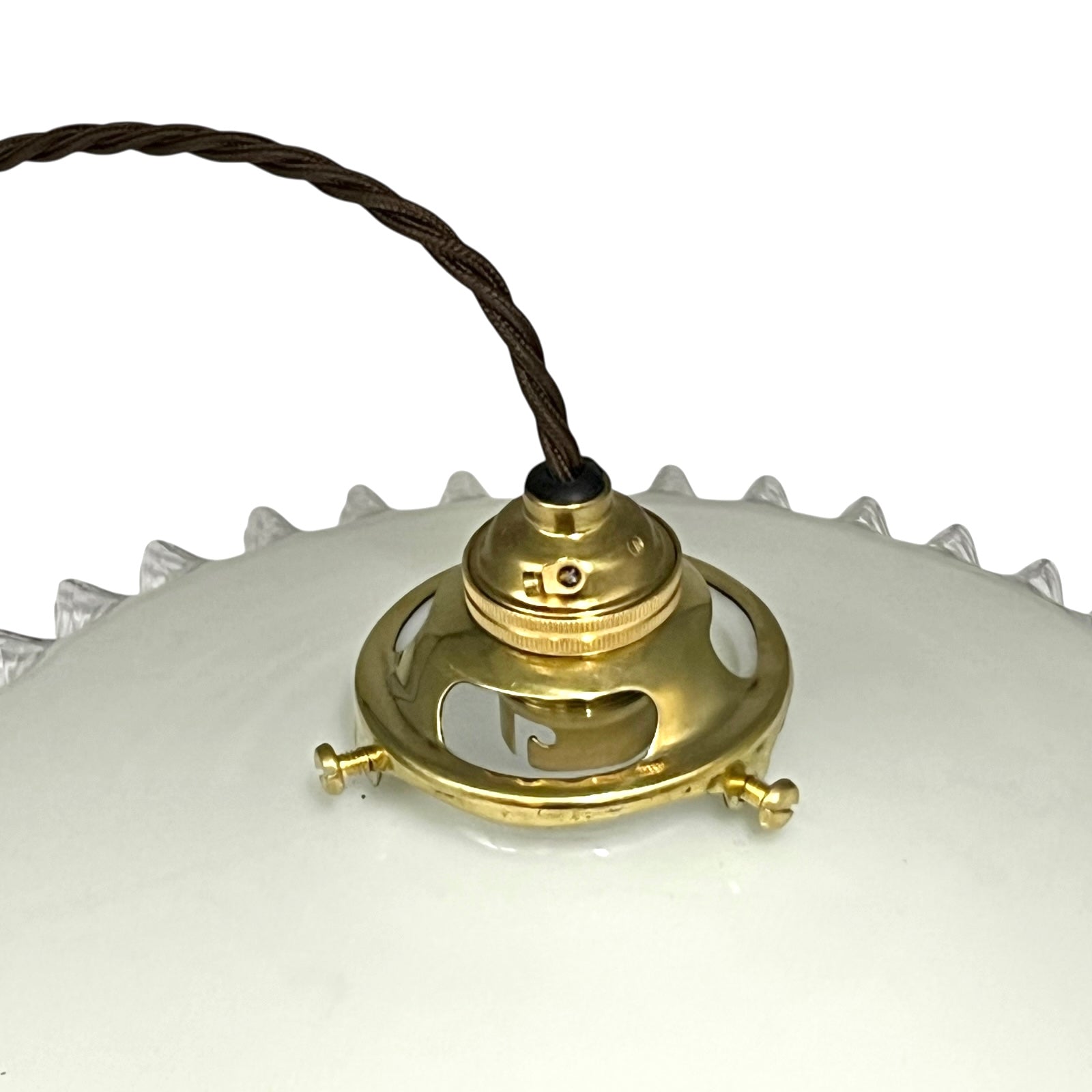 Brass ceiling light fixture with white glass shade on a white background