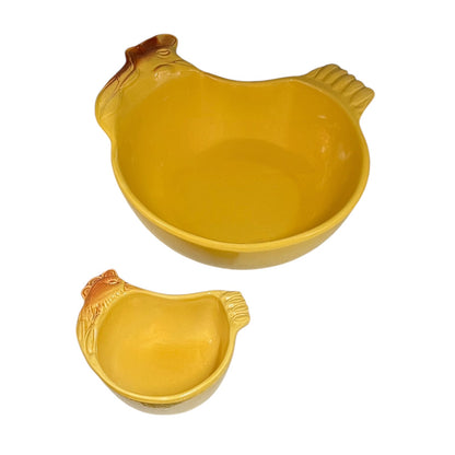Two yellow chicken-shaped ceramic bowls, one large and one small, shown on a plain white background.