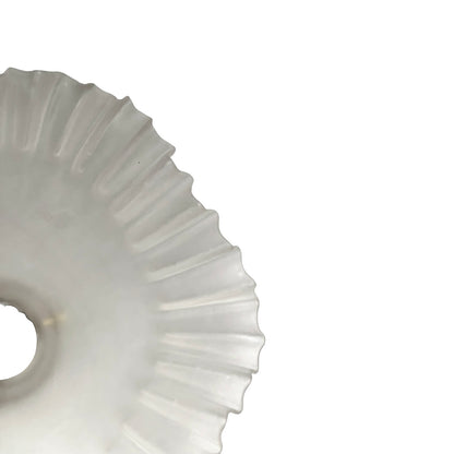 Close-up of a glass lamp shade with a scalloped edge on a white background