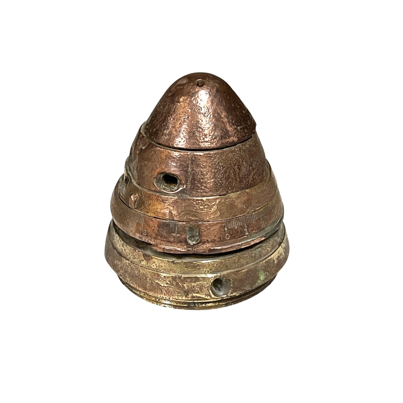 WW1 brass fuse now repurposed as a paperweight, with markings for identification of wear, on a white background
