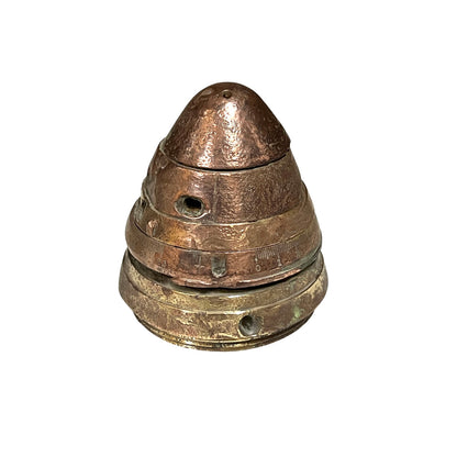 WW1 brass fuse now repurposed as a paperweight, with markings for identification of wear, on a white background