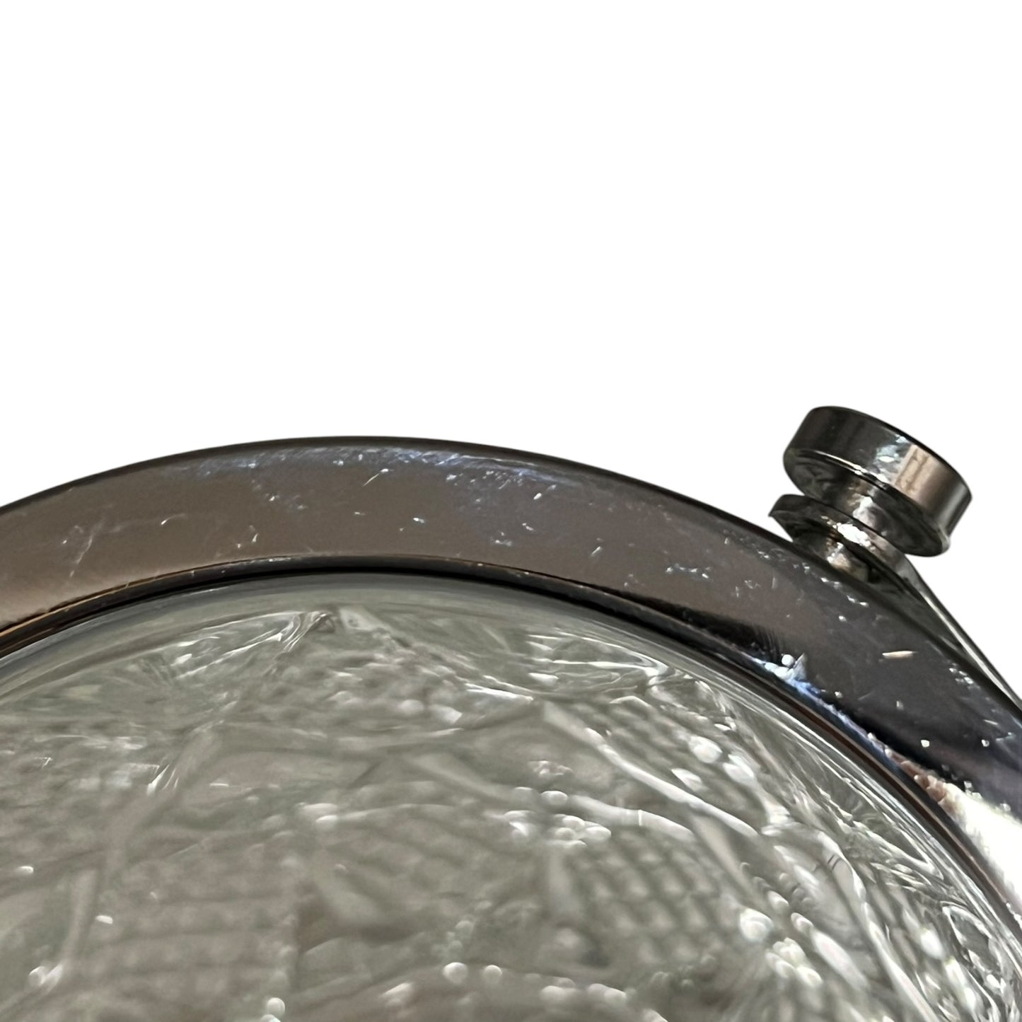 Close-up of a crystal ice bucket with silver lid and handle on a white background