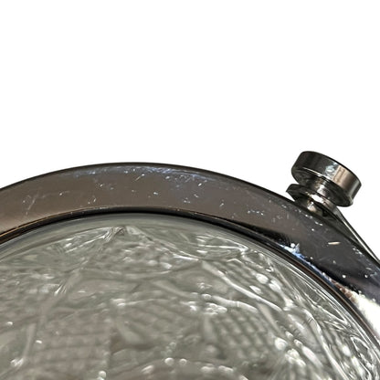 Close-up of a crystal ice bucket with silver lid and handle on a white background