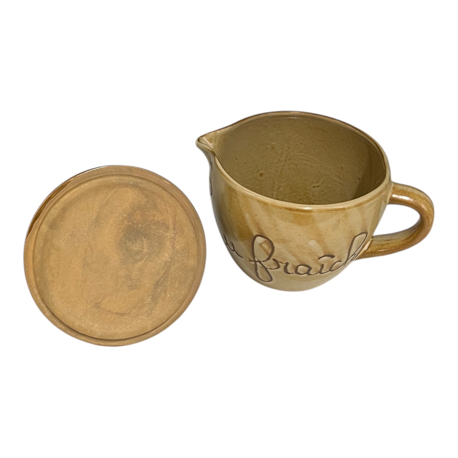 Brown ceramic pitcher with handle and lid on a white background