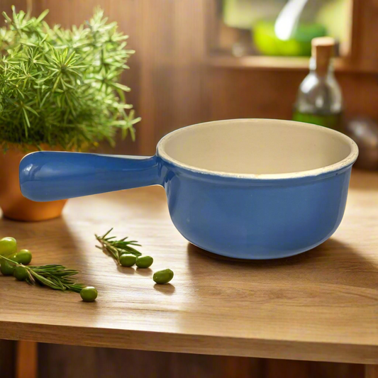 Blue saucepan on a wooden surface with rustic kitchen in the background