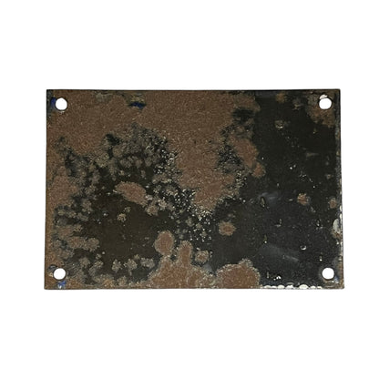 Rust-patterned metal plate with two holes on a white background
