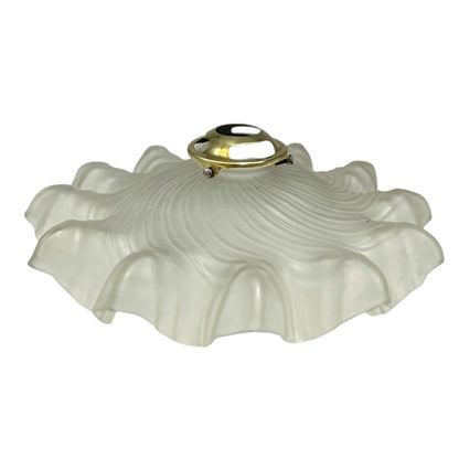 Vintage-style light fixture with frosted glass shade and brass fitting on a white background
