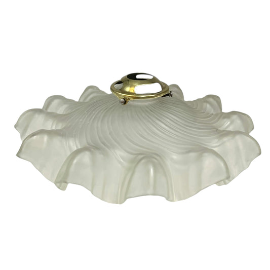 Vintage-style light fixture with frosted glass shade and brass fitting on a white background