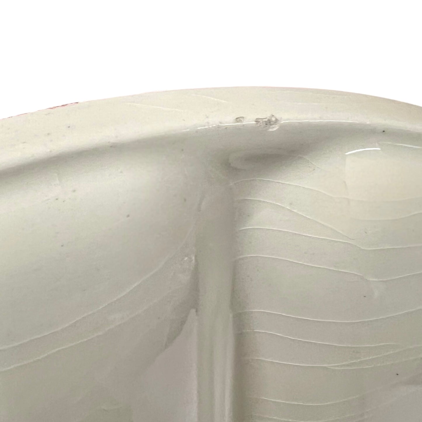 Close-up of a vintage fondue plate with detailed design on a white background