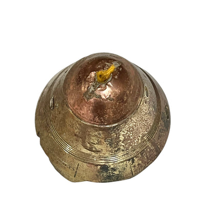 Close up of WW1 relic brass fuse on a white background