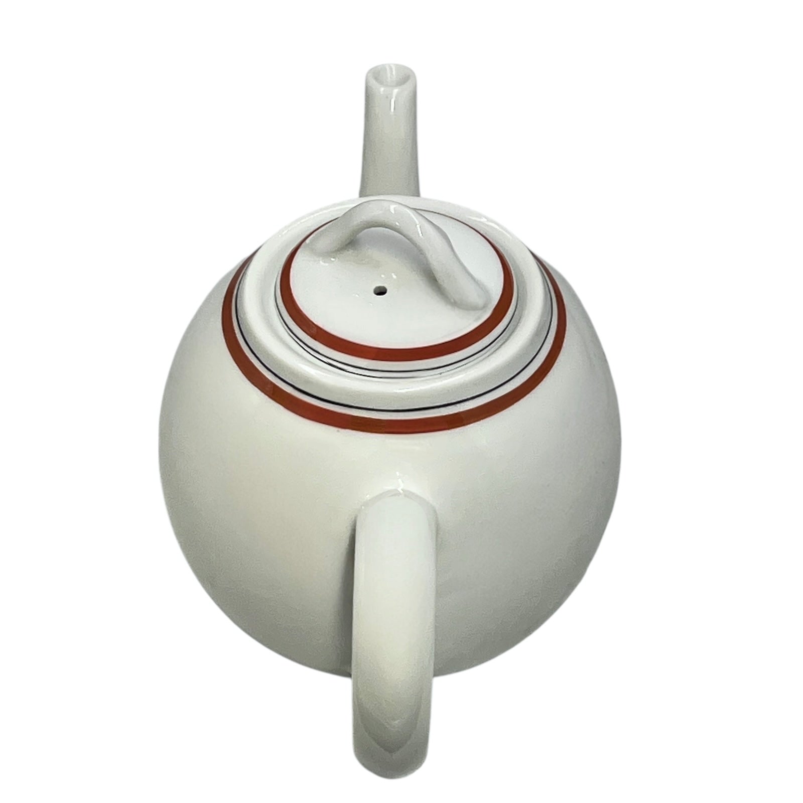 White teapot with red orange rim on a white background