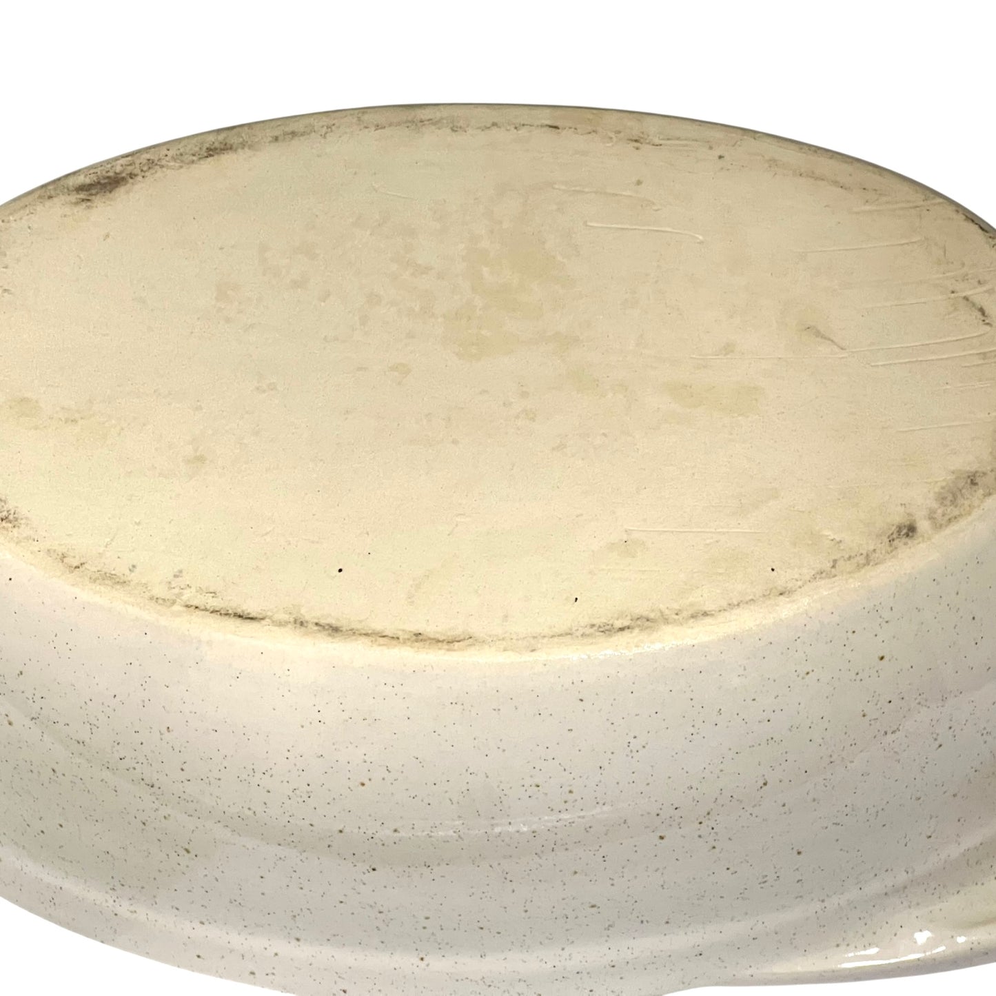 Round ceramic plate with a speckled beige and brown design on a white background