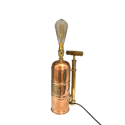 Copper and brass lamp with vintage design on a white background