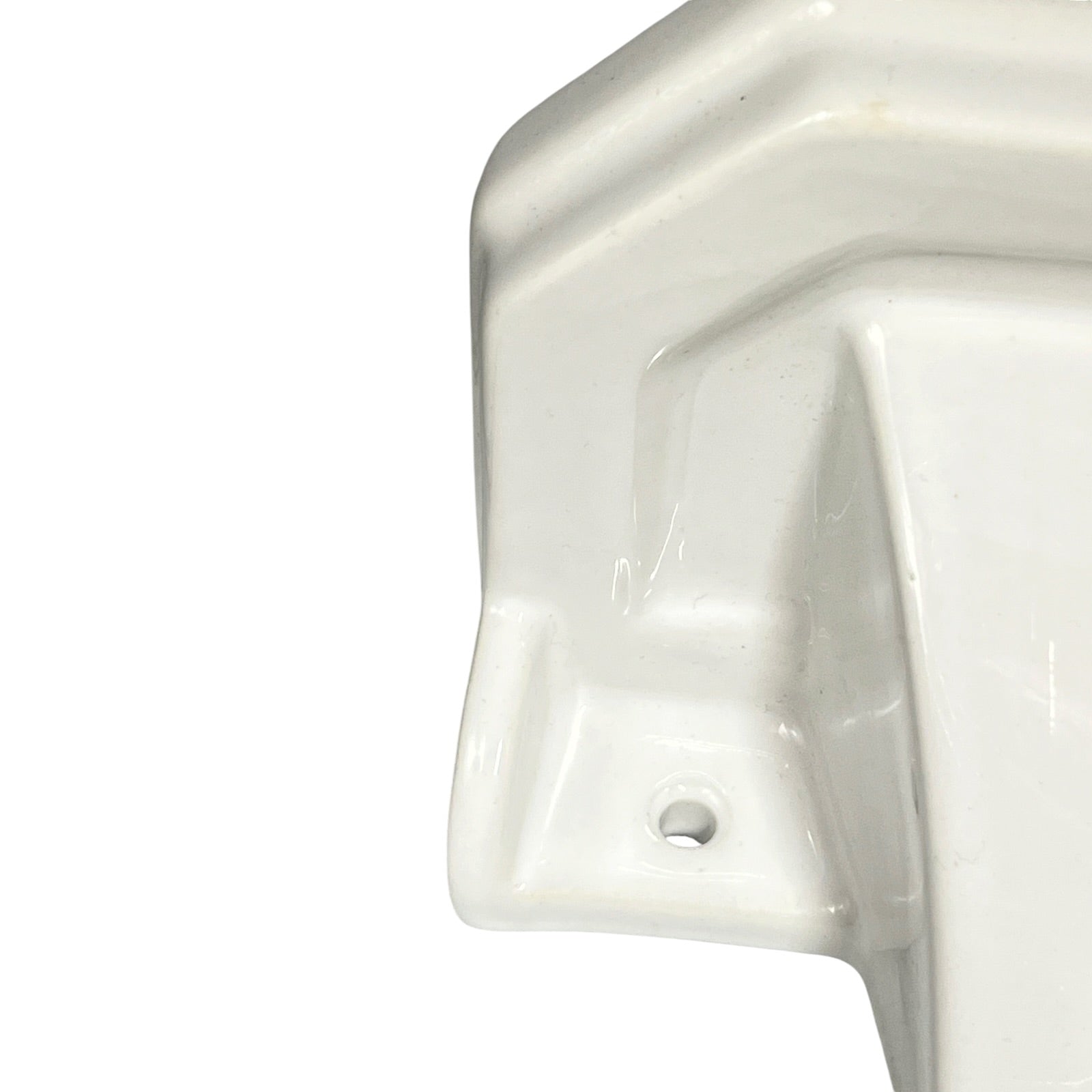 Close-up of a white ceramic shelf with geometric design on a white background