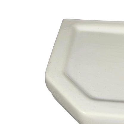Close-up of a white ceramic shelf basin on a white background