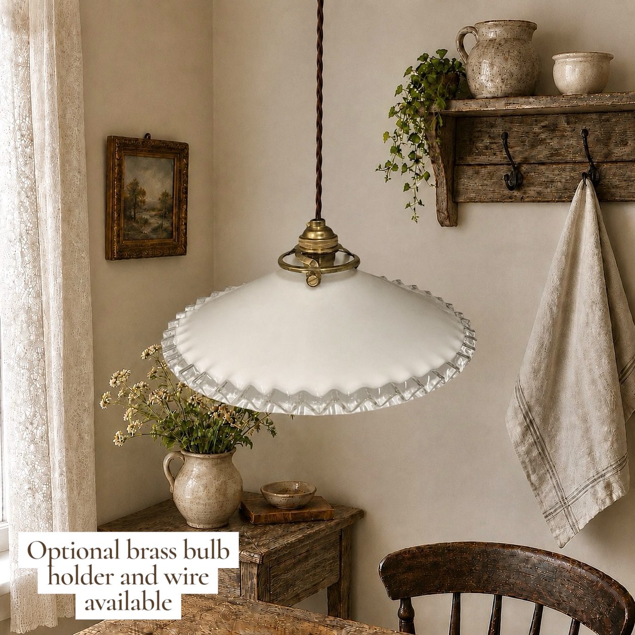 French milk glass pendant light hanging from a ceiling in a rustic farmhouse setting with a brass fittings and twisted wiring