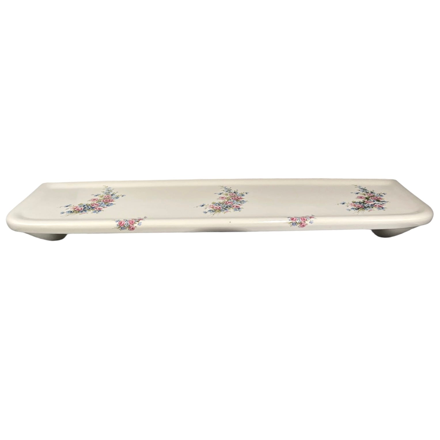 A French vintage ceramic shelf white with a floral pattern on a plain white background.
