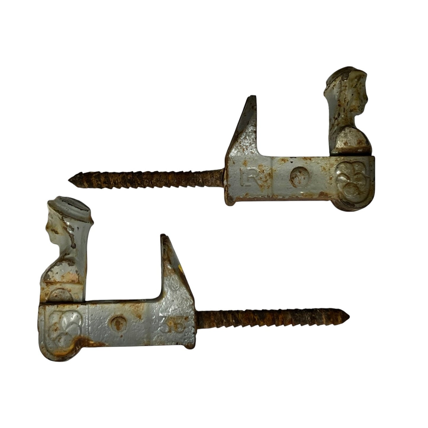 Two vintage metal shutter dogs with threaded screws, showing weathered silver and rusted brown patina on a plain white background.