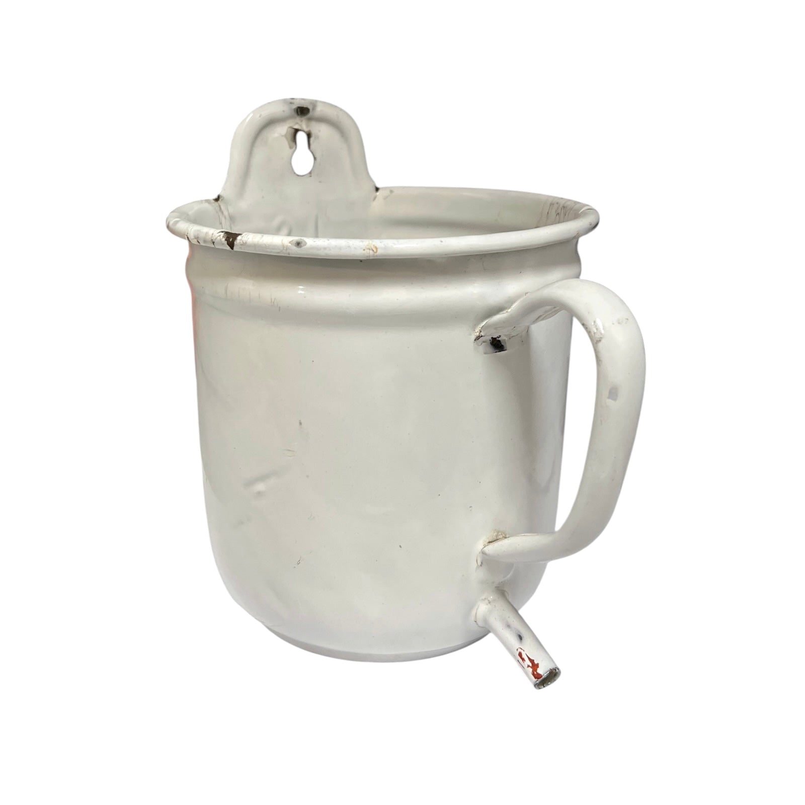 A vintage white enamel pot  with a side spout and a hanging loop on the rim, shown against a plain white background.