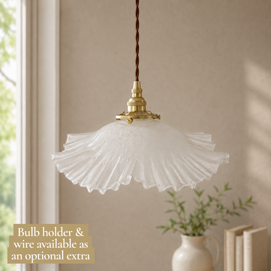 Vintage-style pendant light with scalloped glass shade in a room setting.