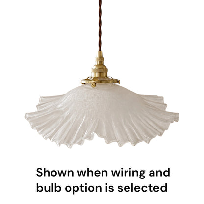 A vintage-style pendant light with a textured, pleated white glass shade and a brass metal fixture, suspended by a dark brown cord. Text at the bottom reads 'Shown when wiring and bulb option is selected'.