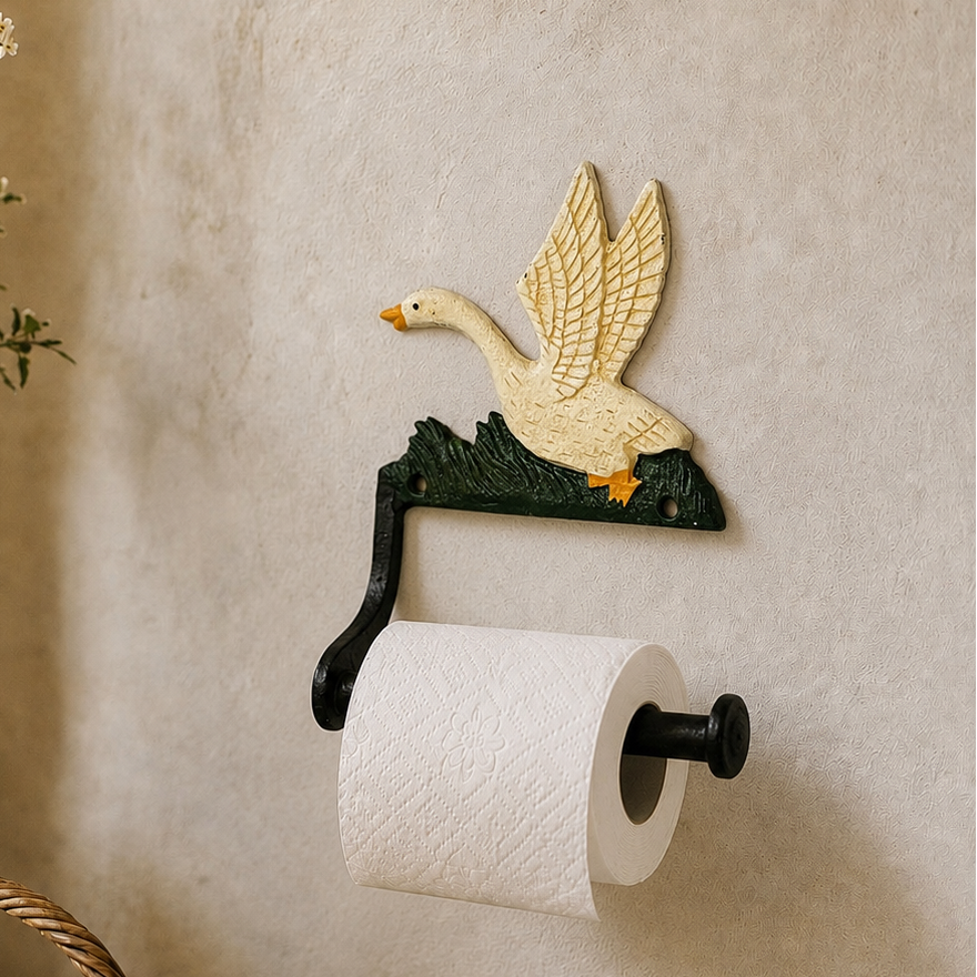 Cast iron goose shaped toilet roll holder on a wall in a rustic bathroom 