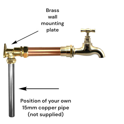 Brass and copper kitchen or bathroom wall taps on a white background