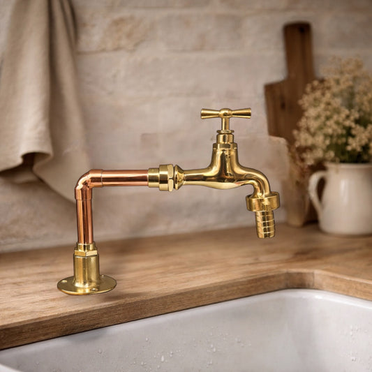 Gold kitchen faucet on a wooden countertop with a neutral background