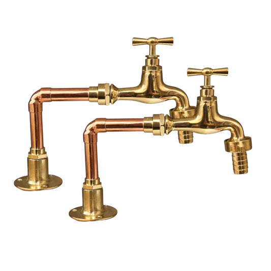 Vintage-style brass and copper faucet set on a white background