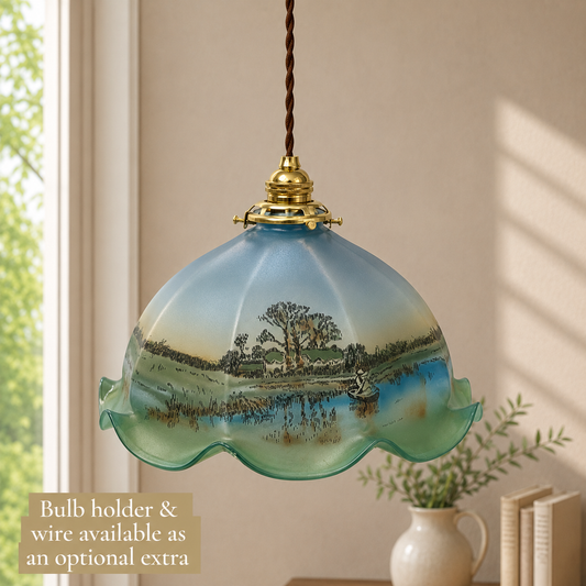 Decorative pendant light with scenic glass shade in a room setting