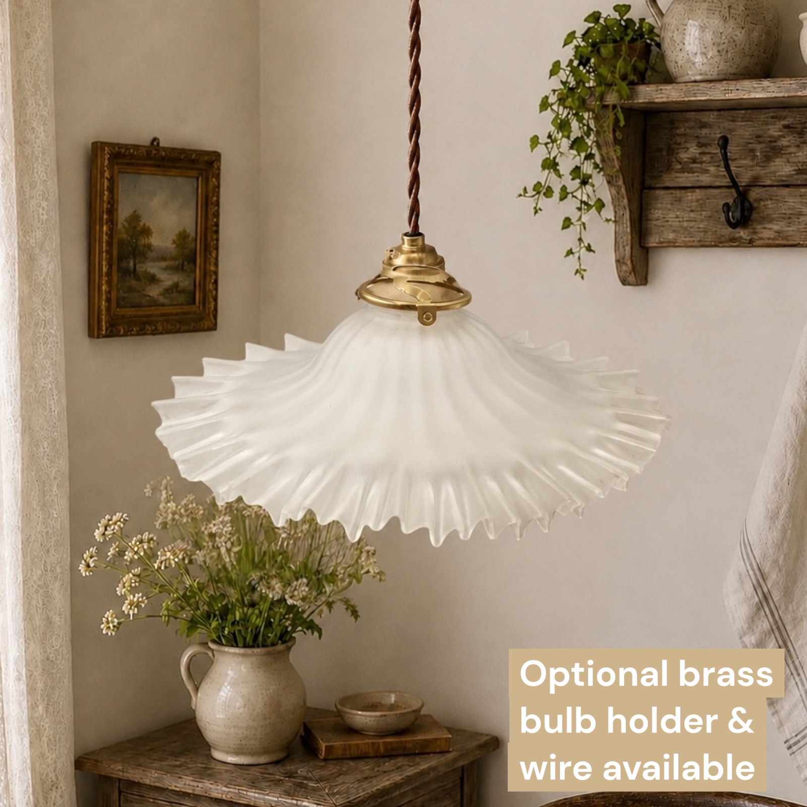 Vintage-style pendant light with white glass shade and brass bulb holder in a home interior setting.