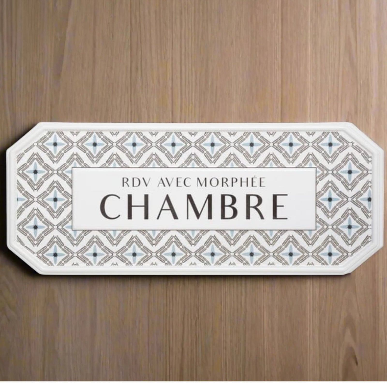 Decorative room sign with geometric pattern and text on a wooden background