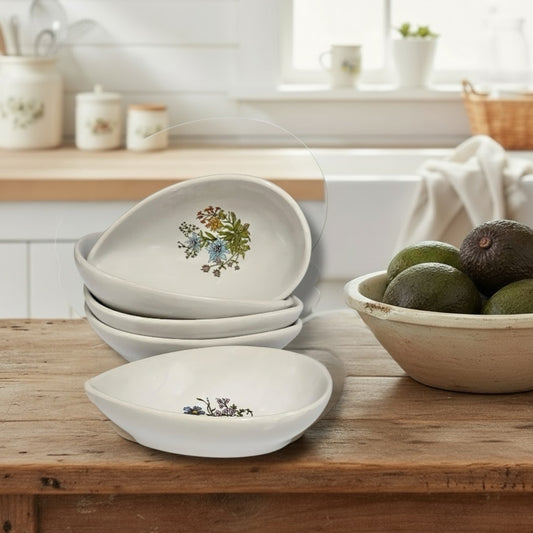 Set of ceramic avocado bowls with floral patterns on a table in a rustic kitchen