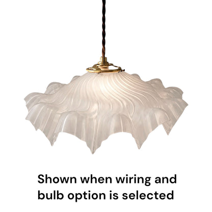 A white fluted glass pendant light shade hanging from a brass fixture with a black cord, shown against a white background with the text 'Shown when wiring and bulb option is selected' below.
