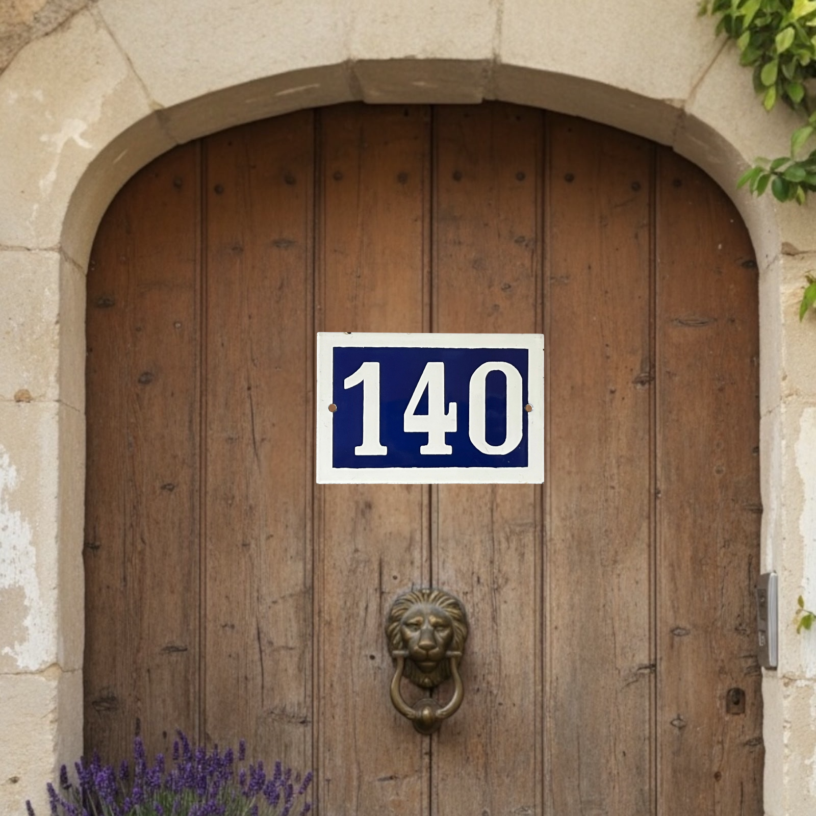 Wooden door with a number 140 sign and a lion knocker.