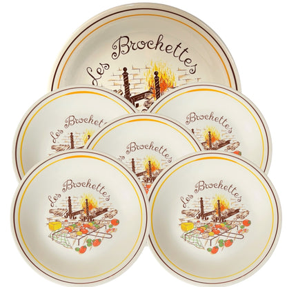 Set of five ceramic plates with 'Les Brochettes' design on a white background