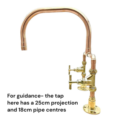 Copper and brass kitchen tap on a white background